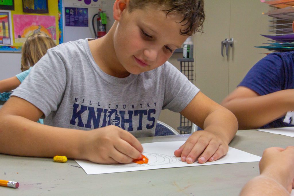 boy in class coloring